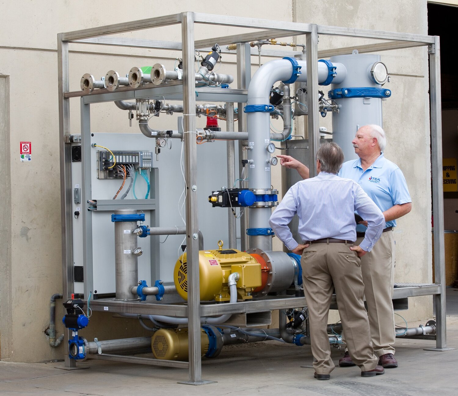 TEA technicians inspecting industrial pump system